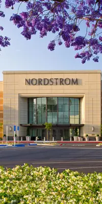 Nordstrom with parking lot and tree